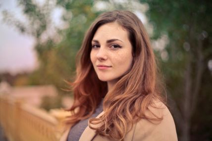 closeup-photo-of-woman-with-brown-coat-and-gray-top-733872